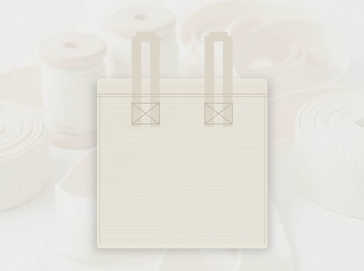 Plain unbranded natural ecru cotton canvas tote bag laid flat on studio tabletop with no exterior labels