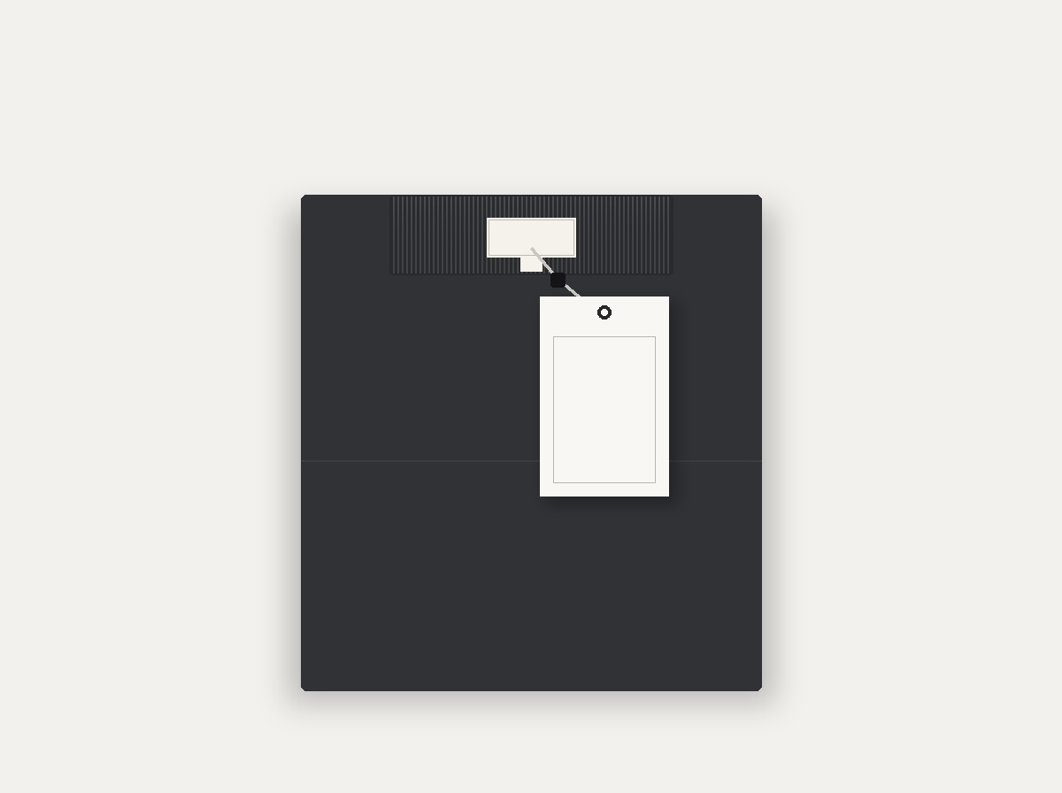 Folded charcoal knitwear featuring an ivory damask woven label in the neck and a debossed cardstock hang tag with seal cord